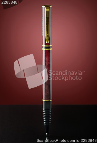 Image of isolated red and golden pen