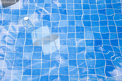 Image of Blue ripped water with blue mosaic in swimming pool