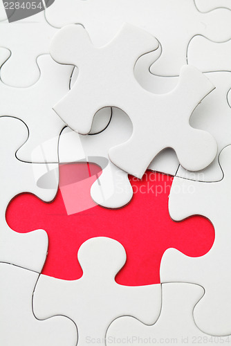 Image of Missing puzzle piece in red color 