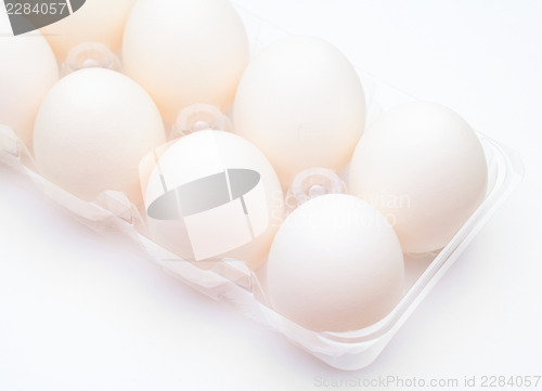 Image of White egg in row