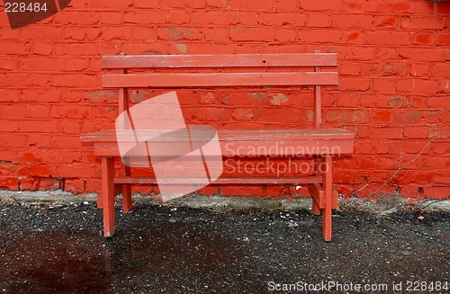 Image of Red bench and brick wall