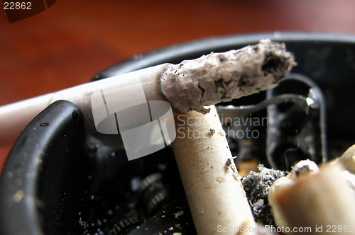 Image of burning cigarrette on ashtray