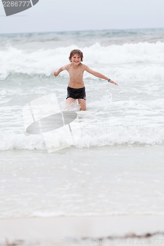 Image of young little boy in water summer holiday fun sea 