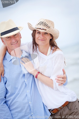 Image of happy adult couple in summertime on beach 