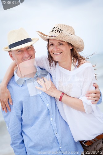 Image of happy adult couple in summertime on beach 