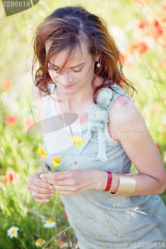 Image of adult brunette woman smiling in summertime outdoor