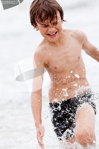 Image of young little boy in water summer holiday fun sea 