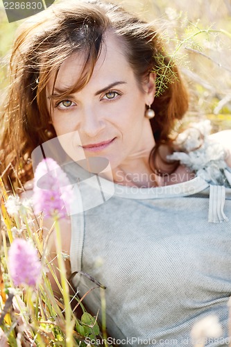 Image of adult brunette woman smiling in summertime outdoor