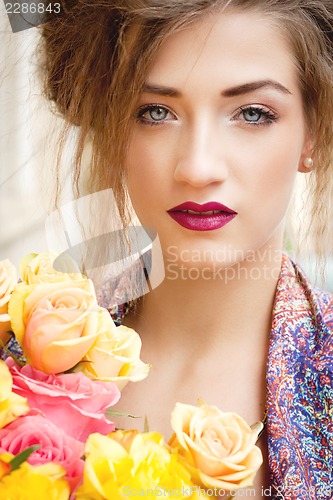 Image of attractive young woman with pink roses