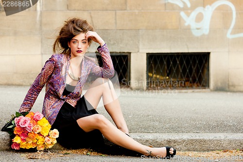 Image of attractive young woman with pink roses