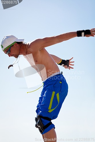 Image of young man with inline skates in summer outdoor 