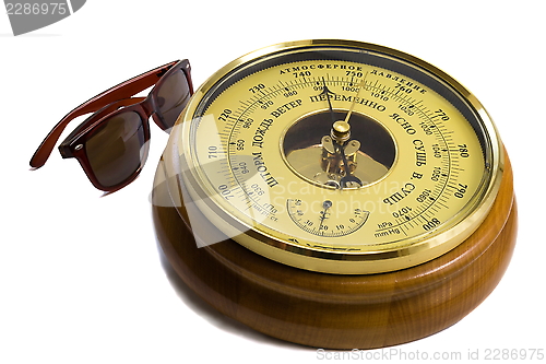 Image of Barometer - aneroid on a white background and black sunglasses