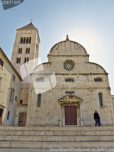 Image of woman in front of church