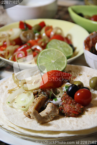 Image of Mexican food with tortillas and nachos 	