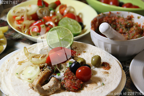 Image of Mexican food with tortillas and nachos 	