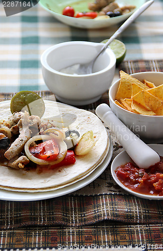 Image of Mexican food with tortillas and nachos 	