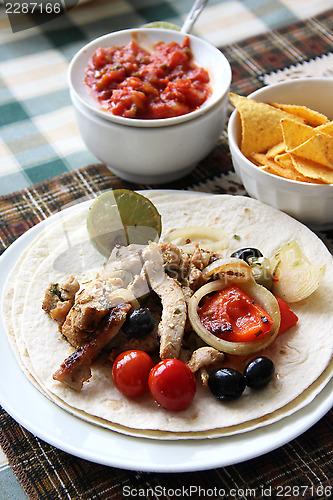 Image of Mexican food with tortillas and nachos 	