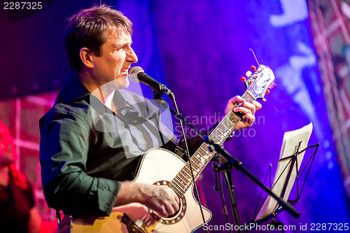 Image of musician plays a guitar