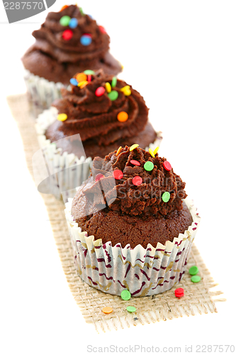 Image of Chocolate cupcakes with colorful decor.
