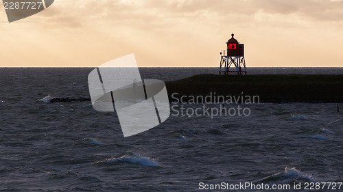 Image of Silhouette of a red beacon at the dutch coast