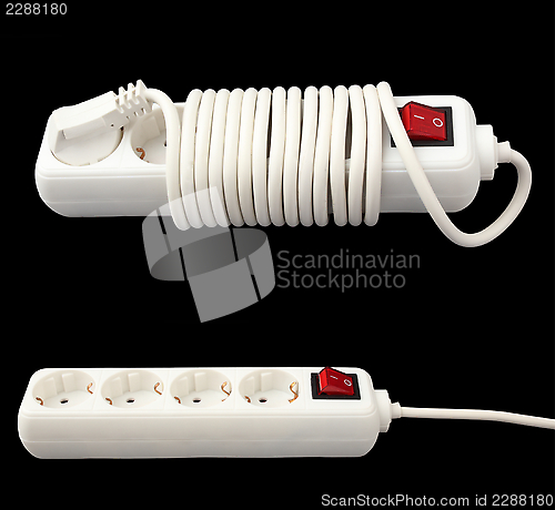 Image of white electric splitter isolated over dark background