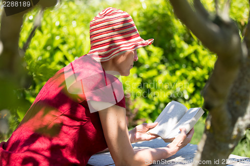 Image of Mature woman reading book