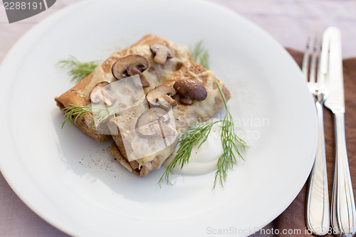 Image of Tasty salty pancakes with mushrooms