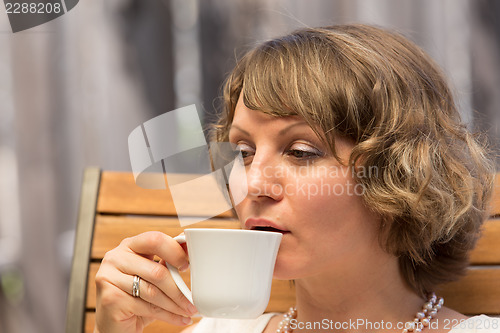 Image of Attractive woman drinking coffee