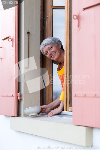 Image of Happy modern senior woman