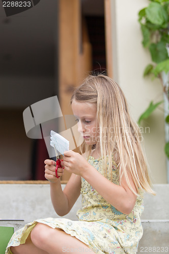 Image of  Little girl cutting paper