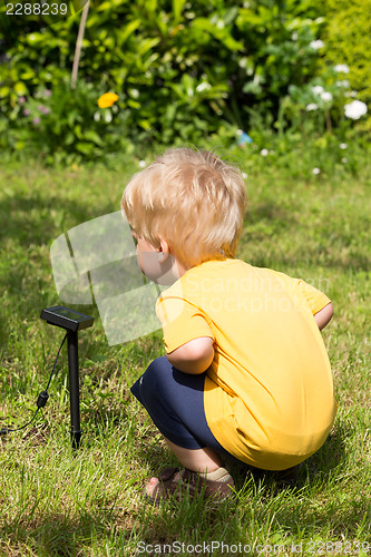 Image of Kid interested by solar battery