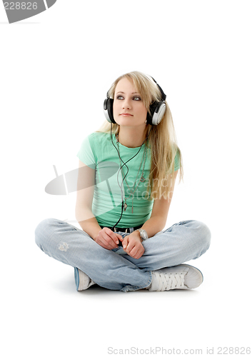 Image of teenage girl in headphones sitting on the floor