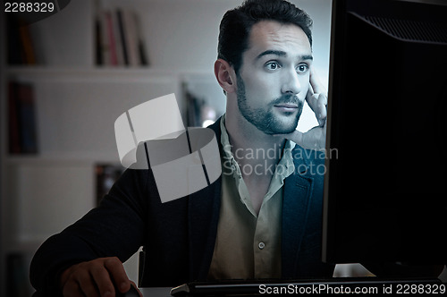 Image of Suprised Man Looking At A Computer Monitor