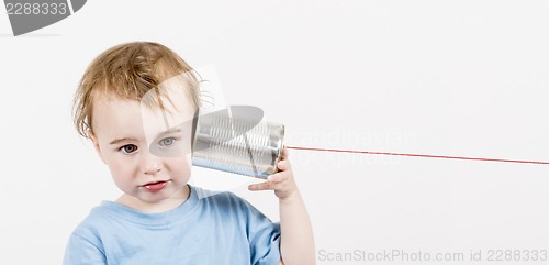 Image of child with tin can phone