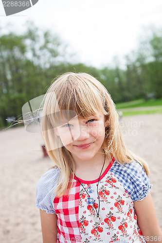 Image of Smiling young girl at beach