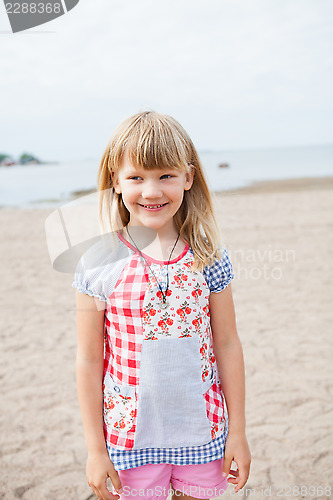 Image of Smiling young girl at beach
