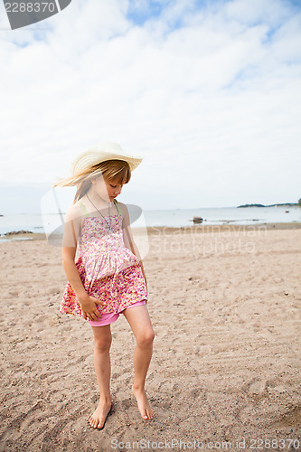 Image of Young barefoot girl at beach