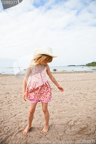Image of Young barefoot girl at beach