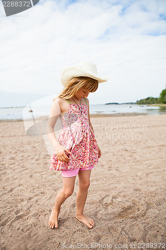 Image of Young barefoot girl at beach