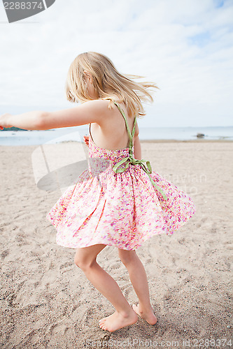 Image of Young girl having fun at beach