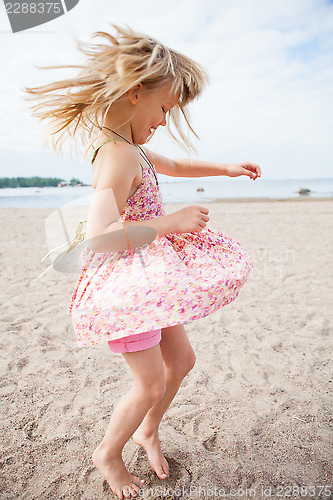 Image of Young girl having fun at beach