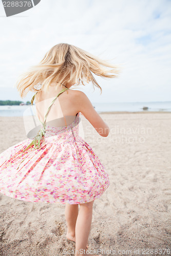 Image of Young girl having fun at beach