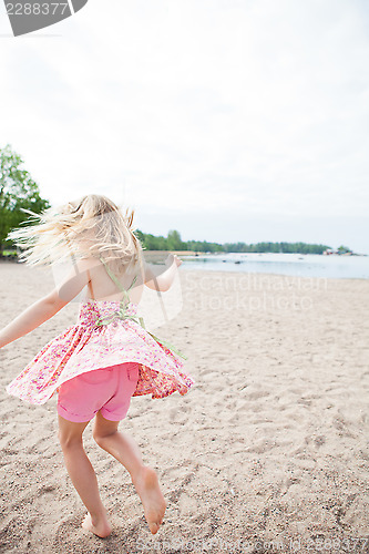 Image of Young girl having fun at beach