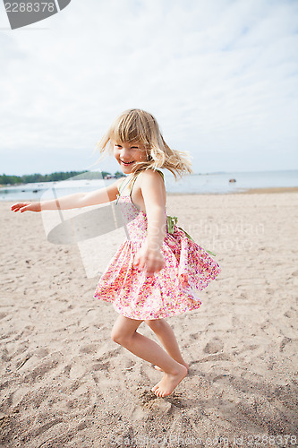 Image of Smiling young girl having fun at beach
