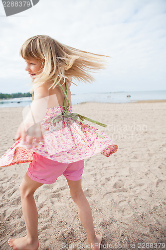 Image of Smiling young girl having fun at beach