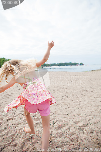 Image of Young girl having fun at beach