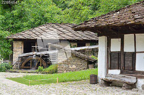 Image of Water mill, an old house and wooden bench in Etara, Bulgaria