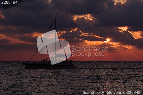 Image of sailing boat sunset red