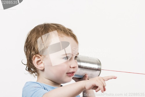 Image of child with tin can phone