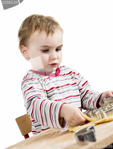 Image of young child isolated in white background baking cookies